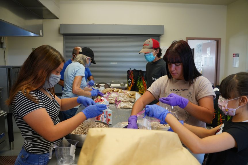 Youth sorting food packages for distribution to community members