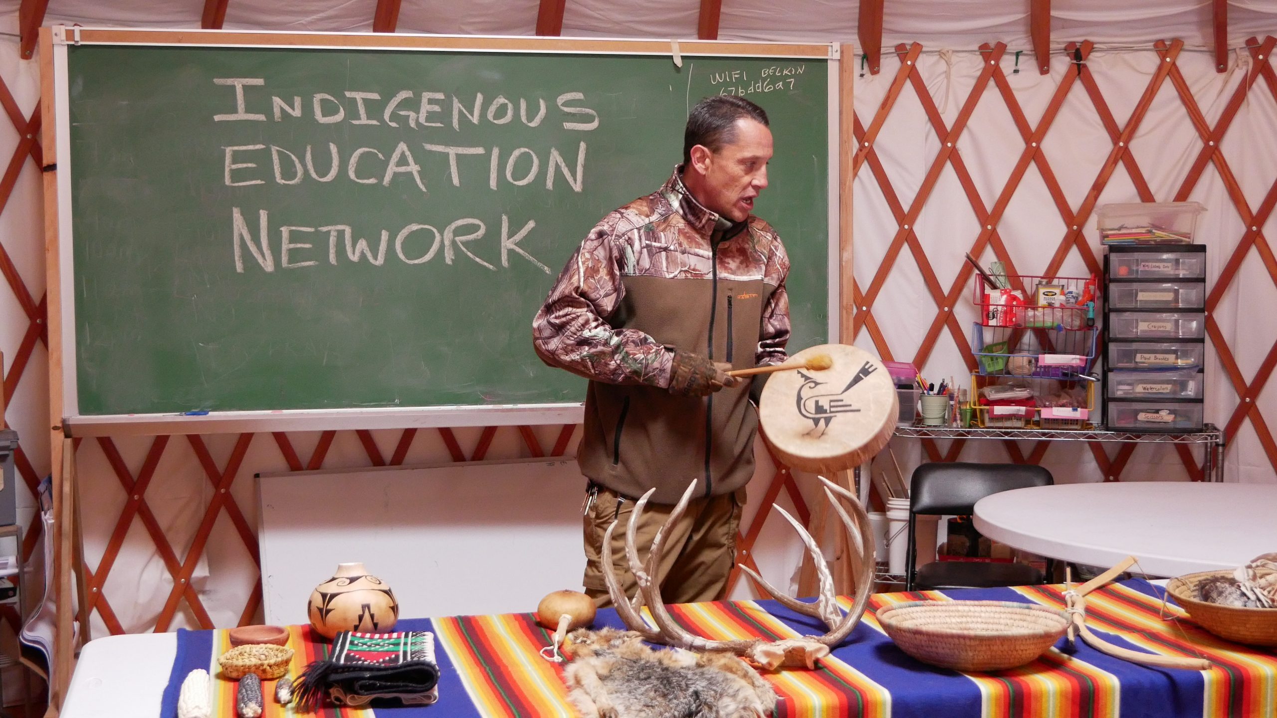 Image depicts an instructor of the Indigenous Education Network teaching a class.